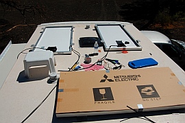 Solar panels being installed on the roof of the RV.