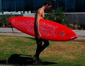 Surfer with his surfboard at Mission Beach San Diego California