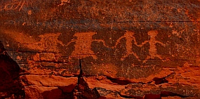 Petroglyph rock art, people holding hands