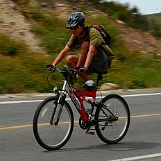 Cyclist does tricks coming down the long descent