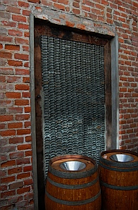 Empty liquor bottles form a window wall at Santo Tomas Winery