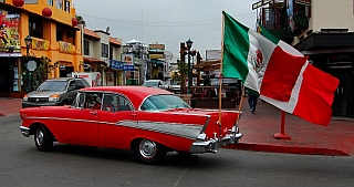 Ensenada vintage car with Mexican flags flying