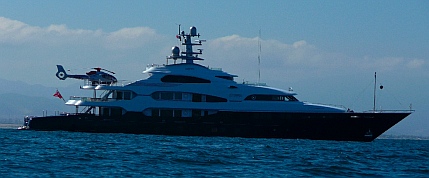 A megayacht too large for Marina Coral anchors outside.
