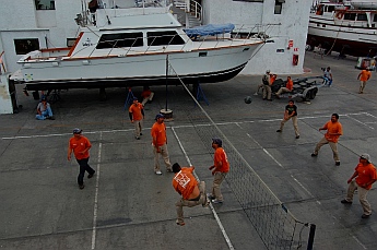 Workers play volleyball at Baja Naval