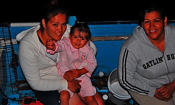 A family on a fishing panga visits in San Evaristo, Baja California Sur, Mexico