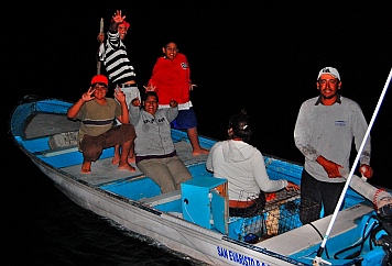 A family on a fishing panga visits in San Evaristo, Baja California Sur, Mexico