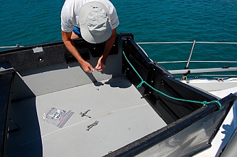 Attaching the transom to the hull with wingnuts.
