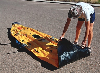 Putting away the Hobie i14t inflatable tandem kayak - First fold the bow in on itself