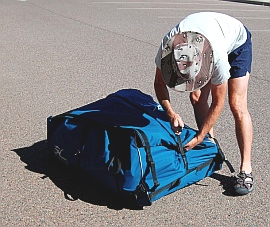 Putting away the Hobie i14t inflatable tandem kayak - tighten the webbing straps.