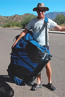 Carrying the Hobie i14t inflatable tandem kayak with a shoulder strap.