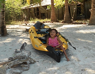 Little girl sits in our kayak at Isla de Ixtapa, Mexico.