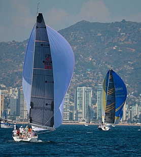 Downwind spinnaker run towards Acapulco's highrises on the beach.