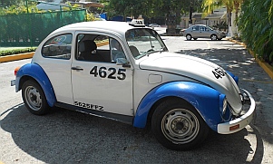 Blue and white VW bug taxis in Acapulco