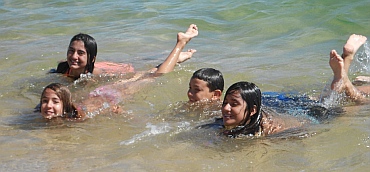 Kids play in the water at Tangolunda Bay, Huatulco, Mexico
