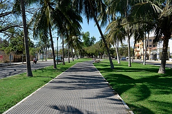 Wide grass-lined sidewalks lead to the town of La Crucecita, Bays of Huatulco, Mexico